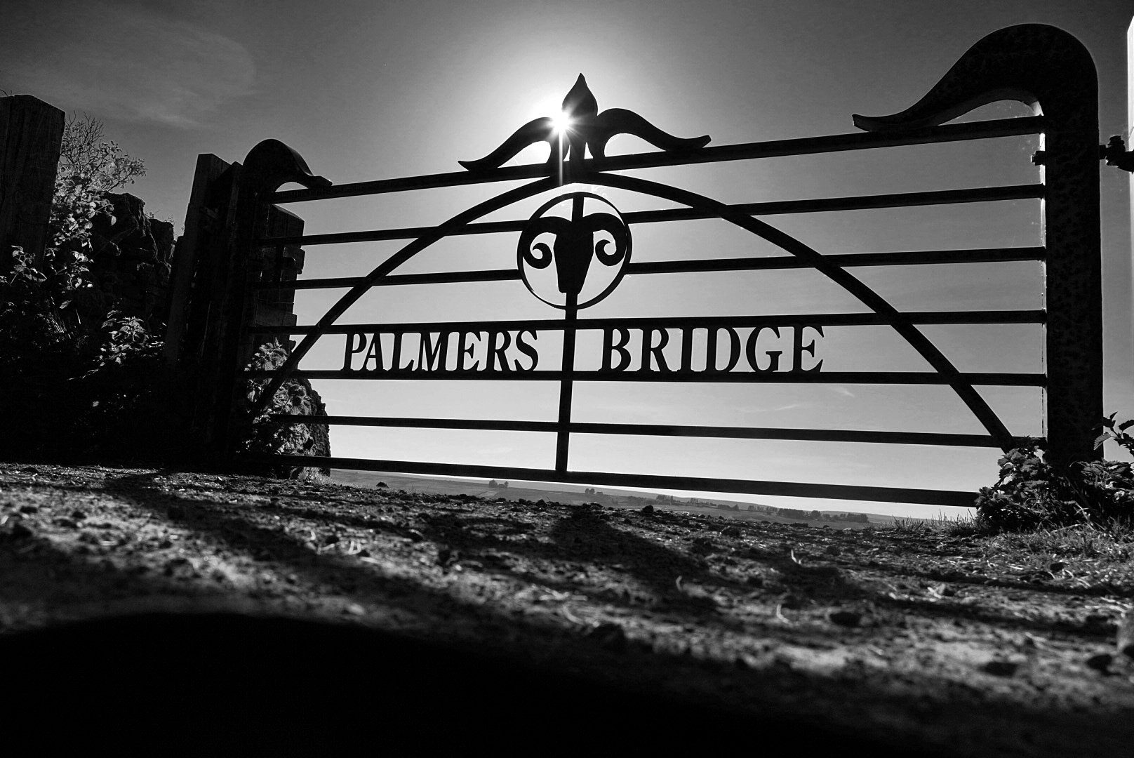 Palmers Bridge iron gate backlit by the sun